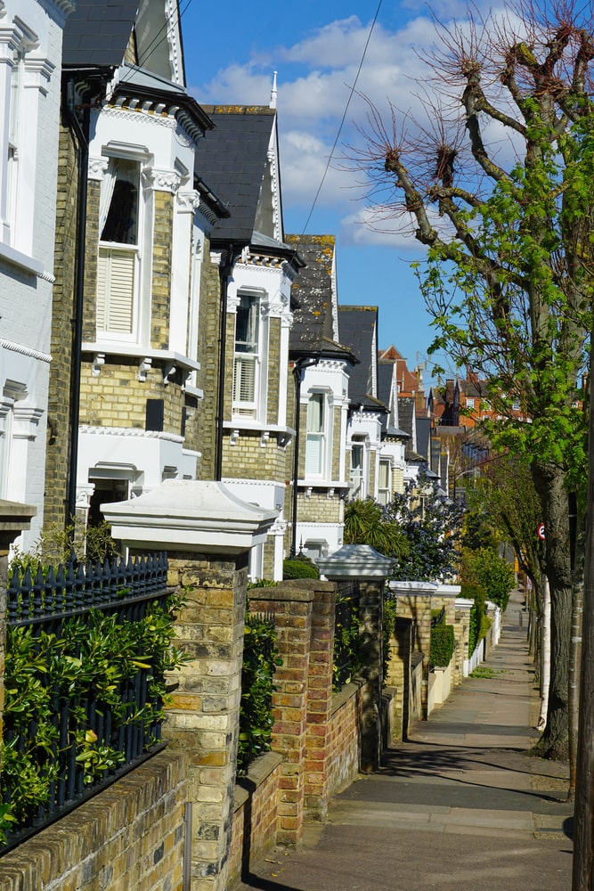 A row of white Victorian houses on a quiet side street near Clapham Junction in South West London-min A row of white Victorian houses on a quiet side street near Clapham Junction in South West London